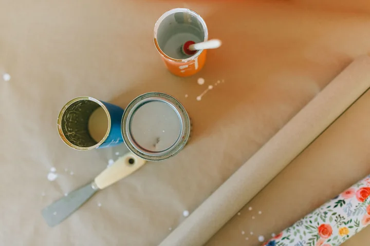 Open tins of paint and a brush, the kind of load a licensed carrier cannot take